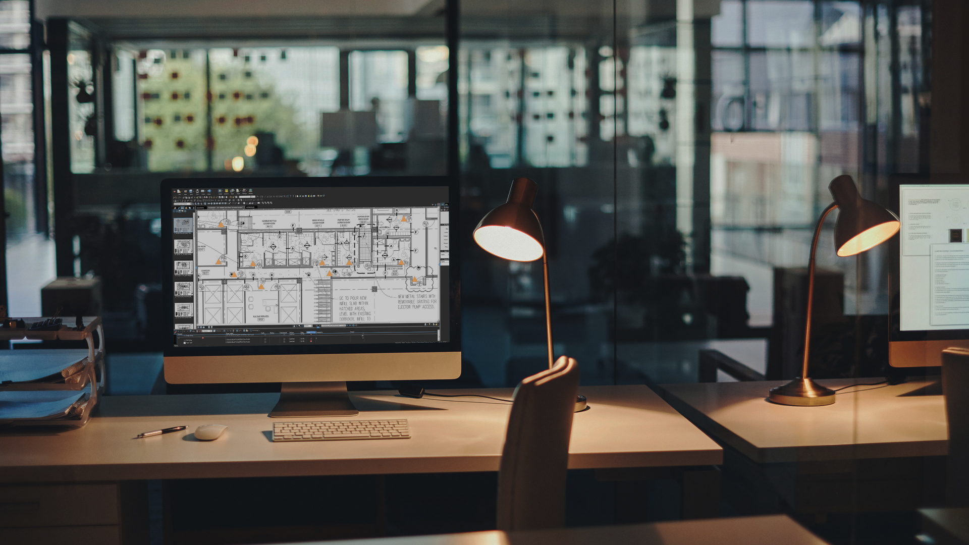 Autocad plans on computer screen in modern office